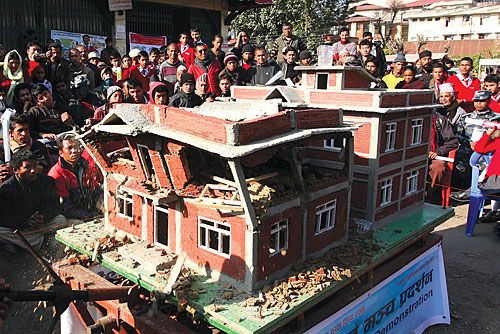 QUAKE DEMO: An earthquake-resistant house stands while a less seismic-proof one crumbles in an "shaking table" demo at Jawalakhel on Monday.
