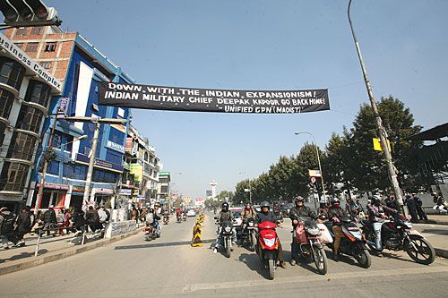 UNWELCOME: Motorcyclists at New Baneswor intersection on Tuesday below a black Maoist banner protesting the visit by the Indian Army Chief, Gen Deepak Kapoor to Nepal.