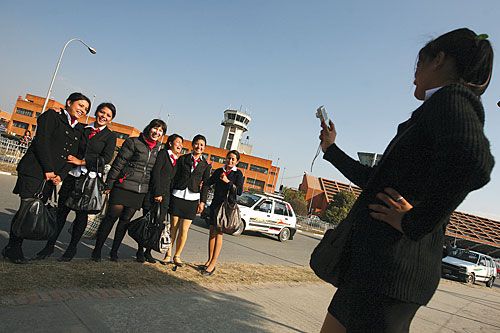 SAY CHEESE: Air hostess trainees take pictures during a tour of Tribhuvan International Airport after completing a three-month course at the Air hostess Training Institute in New Baneswor, Wednesday.
