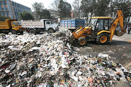 HEAVY LIFTING: Nepal Armed Police employ a dozer to pick up trash at New Road Gate last week as employees of local bodies continued their nationwide protests.
