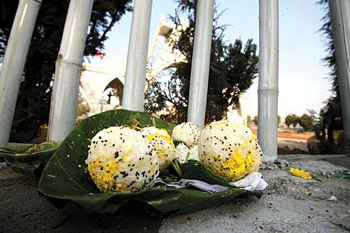 REMEMBRANCE: An offering of rice at Shahid Gate to mark Martyr's Day on Saturday.
