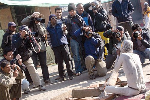 CELEBRITY SADHUS: Photographers jostle to click one of thousands of holy men converging on Pashupatinath for Maha Shivaratri, Thursday.