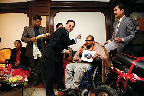 UP AND ABOUT: Disabled journalist Gajendra Budathoki is presented with a specially equipped scooter by Everest Insurance Company Ltd, Monday.