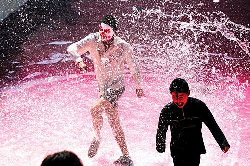 SPLASH: Children wearing face-paint frolic in a pool in Kathmandu to celebrate Holi on Sunday.
