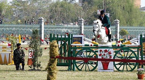 GIANT LEAP: A jockey rides his horse over a fence in Tundikhel during a parade by the Nepal Army on Ghodejatra, the festival of horses.