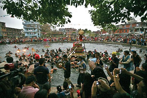 INTO THE BLUE: Devotees pull a chariot into Gahana Pokhari, Handi Gaun in celebration of Gahana Khojne Jatra.