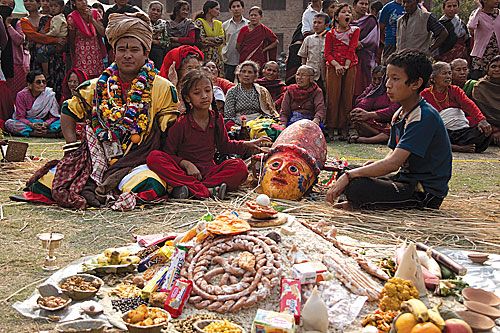 THE FIERCE ONE: A priest and children watch over a mask of Durga during Navadurga in Bhaktapur last week.