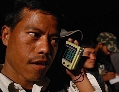 RADIO MAN: A Maoist supporter listens closely to the radio on the results of the election outside the counting centre at Pulchok on Friday night.