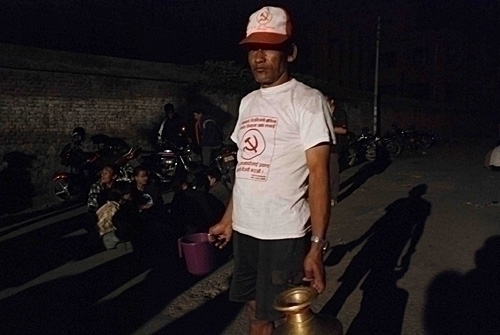 FOR THE MASSES: Maoist supporter Buddha Lal Maharjan makes many round trips to bring water to party supporters in Pulchok.