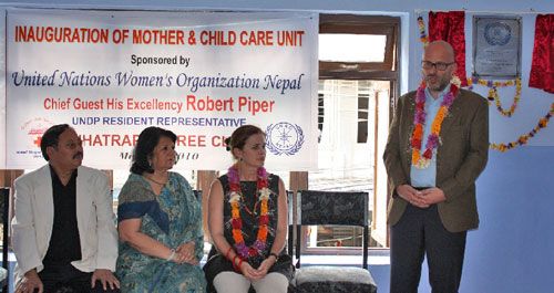 TAKE CARE: UN Resident and Humanitarian Coordinator Robert Piper prepares to hand over a cheque for Rs 1 million from the United Nations Women's Organisation to the Chhetrapati Free Clinic to set up a Mother and Child Care Unit, Sunday.