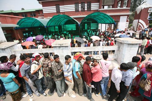 EYES ABROAD: Passport applicants wait outside the Ministry of Foreign Affairs, the only office issuing passports, after the government failed to meet the deadline for machine readable passports.