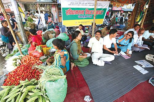 JUST ANOTHER DAY: A vendor sells vegetables as members of the Nepal Federation of Indigenous Nationalities stage a sit-in in front of the CA building on Tuesday demanding the CA's extension.