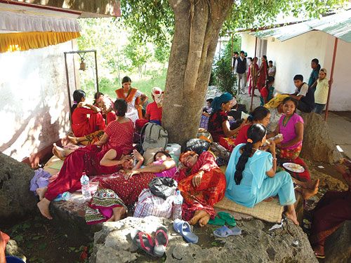 RELIEF? Women rest under a tree for want of beds at Parbat District Hospital, where a free health camp treated 50 women suffering from uterine prolapse, Monday.