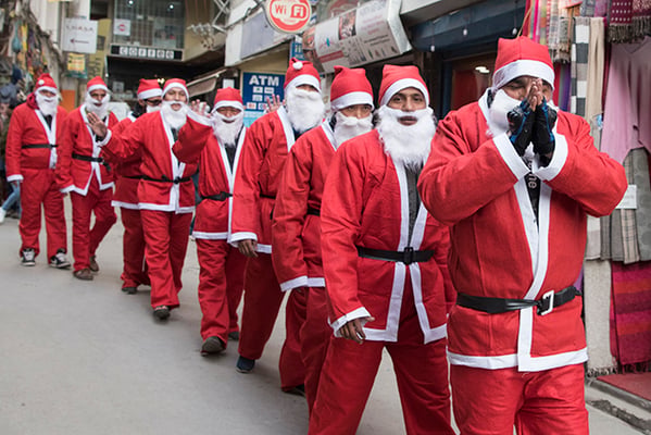 A queue of Santas snake through the streets of Thamel on Friday to welcome the Christmas Season.
