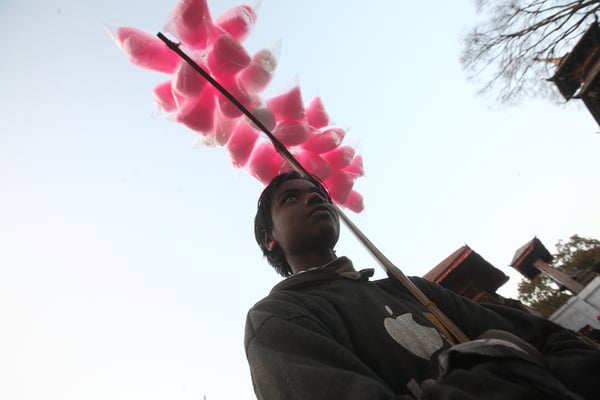 SWEET RESPITE: A cotton candy vendor takes a breather at Basantapur on Monday.