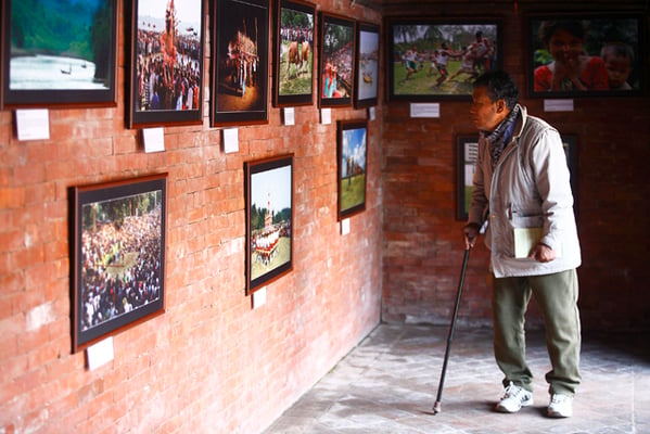 A visitor observes the photographs at 'My Soil My Soul' photo exhibition organized by Chittagong Photojournalist Association at Patan Museum, Lalitpur on Thursday.