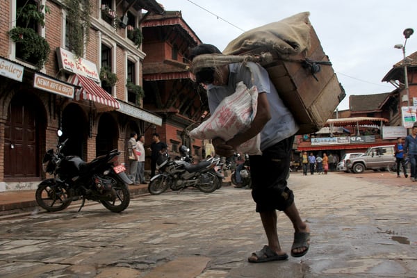 A porter gathers his belongings and makes his way home on Wednesday evening.