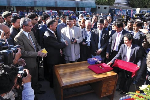 MAKE WAY: Minister for Foreign and Home Affairs Madhav Prasad Ghimire (right) receives 716 vehicles as election aid from Indian ambassador Ranjit Rae (left) on Wednesday.