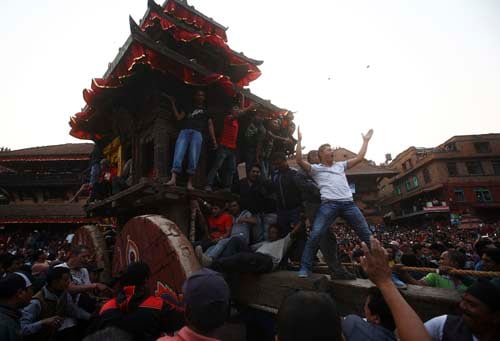 Devotees pull the chariot of god Bhairab through the city center of Bhaktapur on Friday.