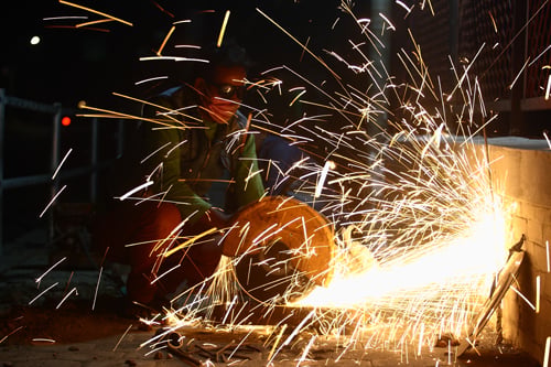 A construction worker repairs the sidewalk near Tripureshwor on Thursday.