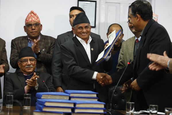 Federal Affairs Minister Hitraj Pandey receives the report prepared by the Local Bodies Restructuring Commission in the presence of Prime Minister Pushpa Kamal Dahal at Singha Darbar on Friday
