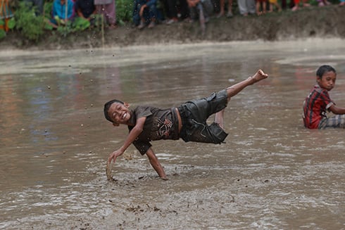 MUDDY DAY: Children play in the paddy fields of Bhaktapur on Saturday and celebrate the rice planting festival.