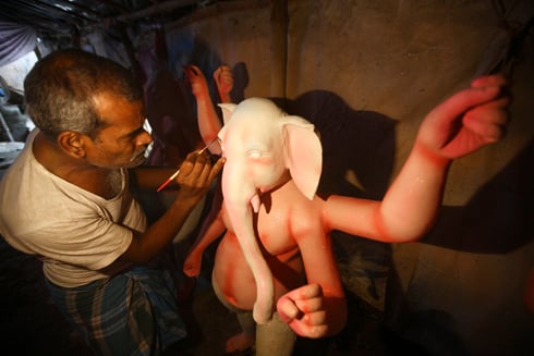FILLING IN: An artisan from Kolkata paints a Ganesh idol near Sanepa on Wednesday.