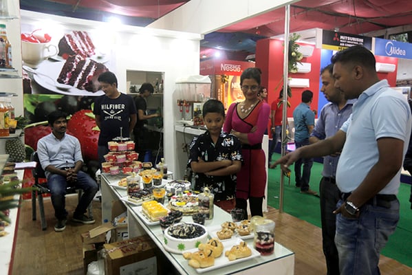 People stand around a food stall during the Food & Beverage and Hospitality event held at Bhrikutimandap, Kathmandu on Saturday.