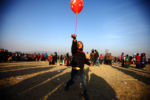 A boy plays with a balloon during the Sonam Losar celebrations at Tundikhel on Wednesday.