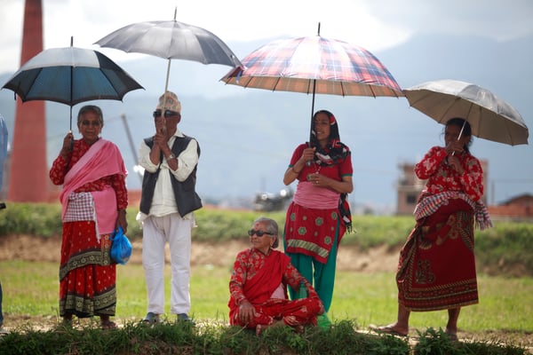 Onlookers watch as people gather to celebrate National Paddy Day in Siddhipur, Lalitpur on Wednesday.
