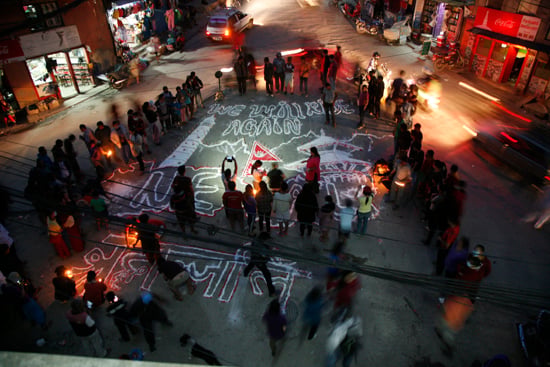 A group of people light candles near Swayambhu on the occasion of Buddha Jayanti on Monday.