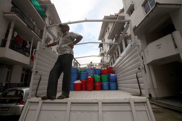 A man waits to load a truck with basic essentials donated for flood victims on Thursday. This was organised by the association of St Mary's Alumnae Nepal.