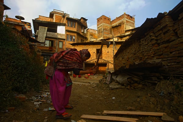 27-year-old Usha Devi Sah chops wood to cook food in Bhaktapur on Sunday. She has been using firewood for more than two months due to the gas shortage caused by the ongoing Indian blockade.