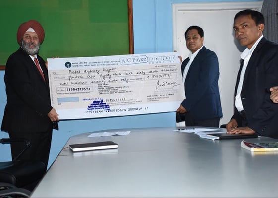 Indian ambassador Manjeev Singh Puri hands over a cheque for Rs 23 million to Transport Secretary Devendra Karki at Singha Durbar Kathmandu. The amount will be spent in building two stretches of the Postal Highway.