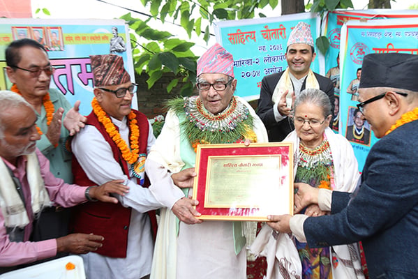 Officers of the Sahitya Chautari of Jhapa honour Nepal's National Poet Madhav Prasad Ghimire at his home in Kathmandu on Thursday.