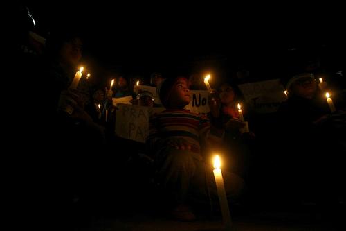 People attend a candle light vigil on Wednesday for the students killed at the military-run Army Public School in Peshawar.