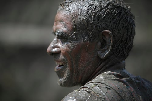 A farmer with mud smeared on his body in Jitpurphedi, Kathmandu on the occasion of National Paddy Day.