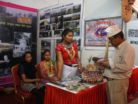 LOOKS GOOD: A guest inspects items from Mehri Handicraft Industry's stall during the 5th National Tourism Fair in Bhrikuti Mandap on Sunday afternoon.