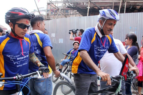 Chief Secretary Lila Mani Poudel takes part in a cycle rally held in Kathmandu on Saturday to raise fund for rebuilding of the earthquake-damage heritage sites.