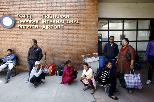 People continue to wait outside a closed Tribhuvan International Airport on Saturday morning.