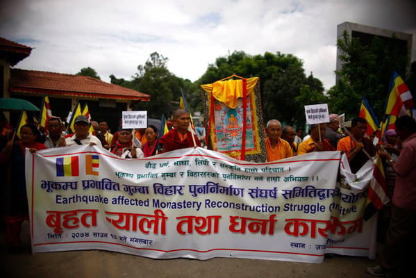 Buddhist monks stage a protest demanding reconstruction of earthquake-hit monasteries in Jawalakhel on Tuesday.