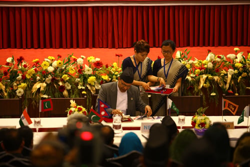 Minister for Information and Communications Minendra Rijal places the cancellation stamp on the Special Commemorative Postal Cover to mark the SAARC Summit on Wednesday.