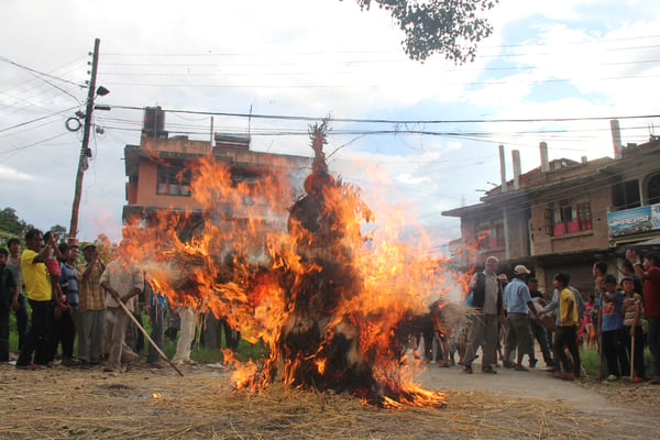 Locals burning an effigy of the demon for Gathe Mangal at the Chundevi temple in Bhaktapur on Friday.