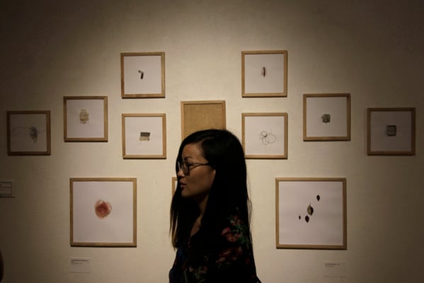A visitor walks by artworks of German artist Lena Koester during an art exhibition titled 'You are the observer' at Artudio on Friday.