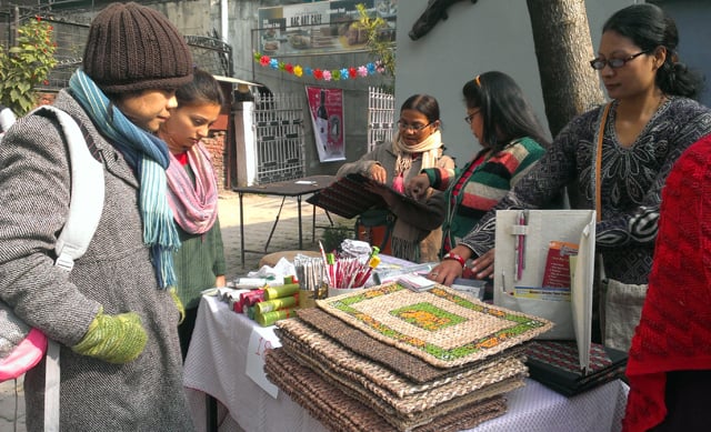 Visitors observe the exhibits at display on 'A Shop with a Story' stall at the Artisan Christmas Bazaar hosted by Bikalpa Art Center, Pulchowk on Sunday.