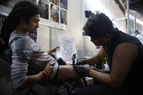 A tattoo artist at work during the Nepal Inked Tattoo and Lifestyle Convention at Bhrikuti Mandap on Saturday.