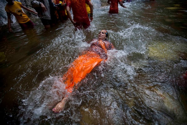 A Hindu devotee takes a holy bath before collecting water from the Bagmati river during the 'Bol Bom' pilgrimage at Sudarijaal on Monday.