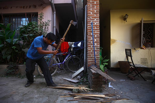 A man chops wood to be used for cooking at a restaurant in Basantapur on Friday. The ongoing fuel crisis has forced many restaurants and hotels to resort to firewood.