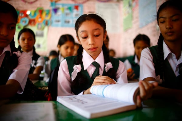Former Kumari, Matina Shakya attends classes on her first day in school at Kathmandu on Monday.