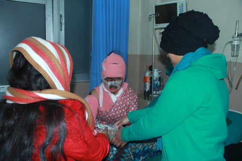 Acid attack victim Sangita Magar receiving a donation of Rs 22,500 on Thursday.